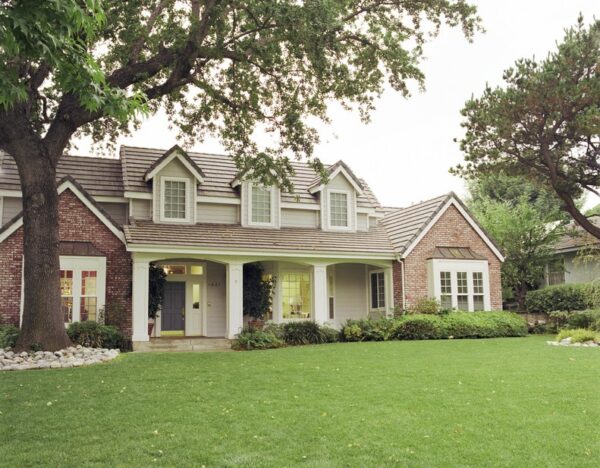 A typical, two-story suburban home with a nice, green lawn.